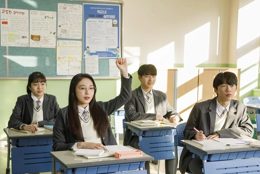 교실에서 손을 들어 질문하는 학생